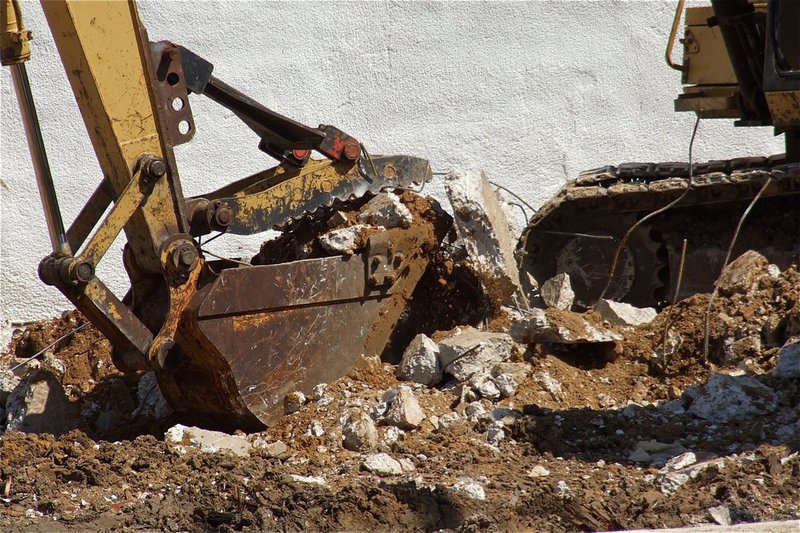 Image: Clearing away the last of the old community center one scoop at a time.