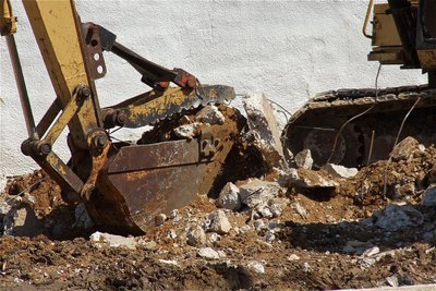 Image: Clearing away the last of the old community center one scoop at a time.