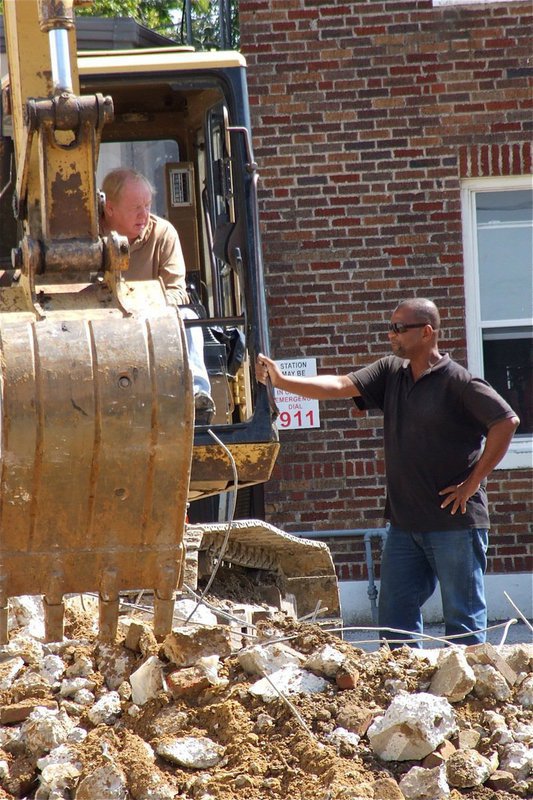 Image: Tufco LLC crew members discuss strategy.