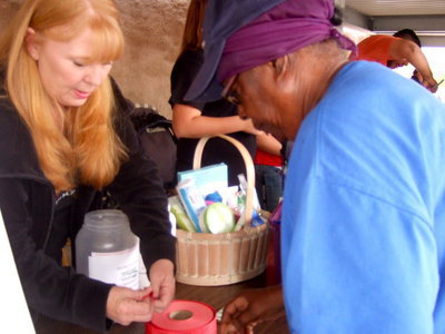 Image: Jeannie Richards with the Titus Women selling raffle tickets for their goodie baskets.