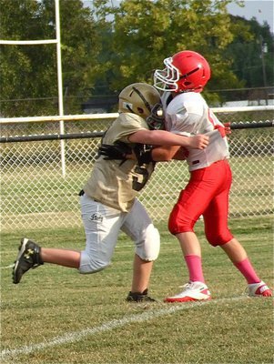 Image: Italy’s 7th grade defense gets pressure on Hico’s quarterback.