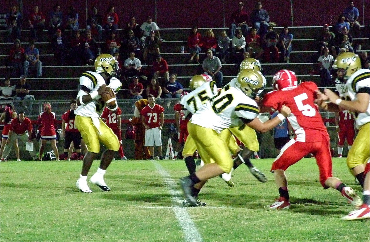 Image: Marvin Cox(3) sits in the pocket behind Cody Medrano(75), Zain Byers(50) and Kevin Roldan(60). Cox completed 12-of-32 passes for 109 yards in his first start at quarterback for Italy.