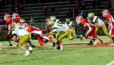 Image: Chase Hamilton(2) and Reid Jacinto(11) combine to stop a Tiger.