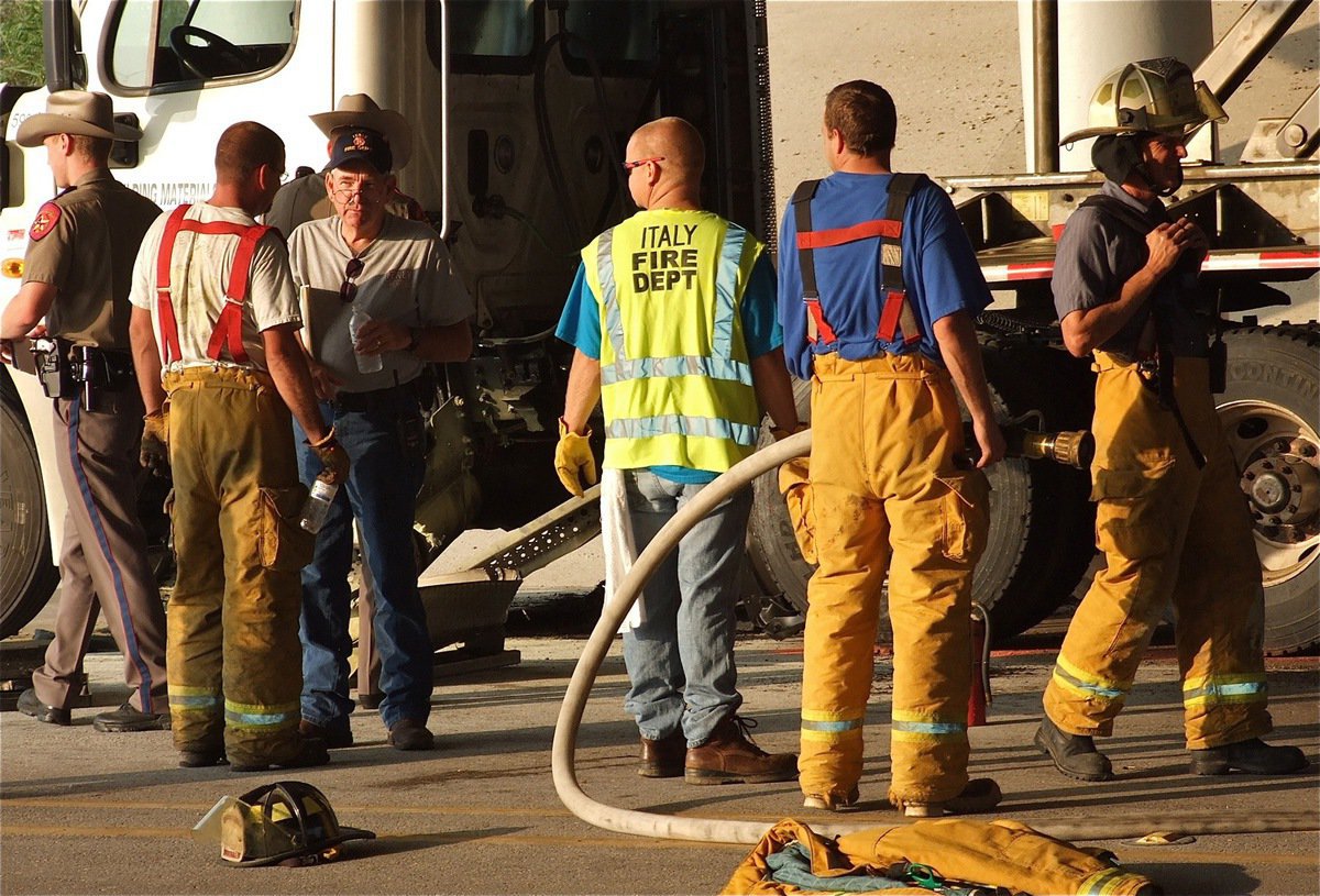 Image: State troopers and local fire fighters conclude the investigation before clearing the scene of the accident.