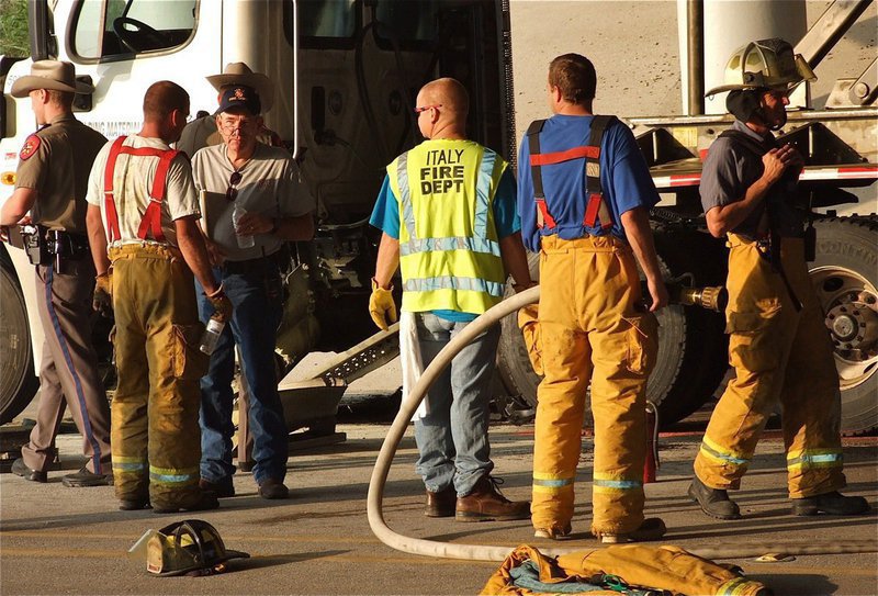 Image: State troopers and local fire fighters conclude the investigation before clearing the scene of the accident.