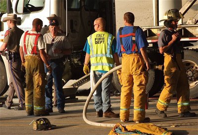 Image: State troopers and local fire fighters conclude the investigation before clearing the scene of the accident.