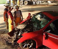Image: Local firefighters Bobby McBride, Paul Cockerham and Michael Martinez assess the damage of the suspects vehicle.