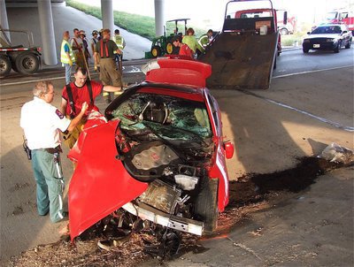 Image: Paramedic Tim Dye, Sr. and Italy firefighter Paul Cockerham discuss the wreckage.
