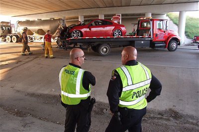 Image: Officer Shawn Martin an Chief Diron Hill of the Italy Police Department monitor the clean up.
