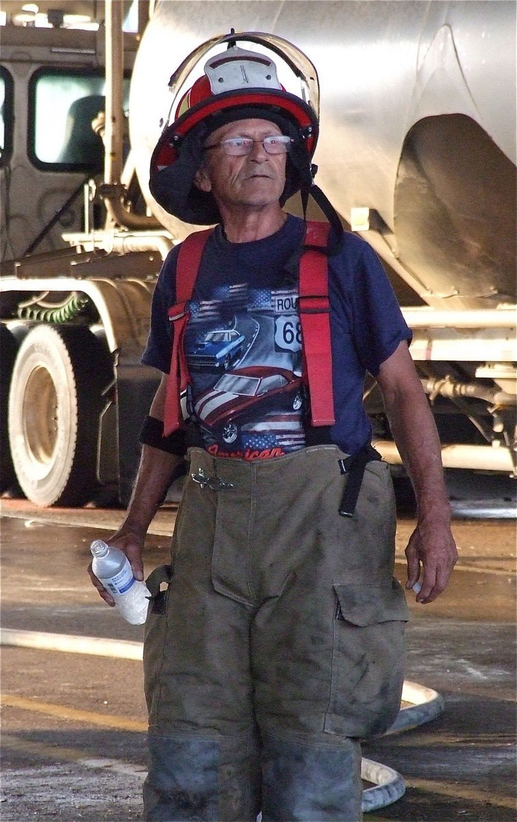 Image: Italy firefighter Sal Perales keeps the pumper engine ready in case the clean up process turns dangerous.