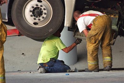 Image: Keith Helms of Helms Garage and IFD’s Brad Chambers prepare the diesel rig for transporting.