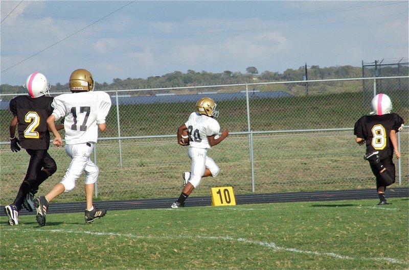 Image: Kendrick Norwood(20) reaches the end zone with Ty Hamilton(17) tracking the ball for Italy.