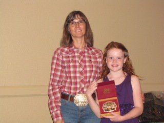 Image: Goldmyne Ranch buckle sponsor Jennifer Alexander presents Sadie Hinz of Italy, right, with the Reserve Champion 11 & Under English buckle. Sadie also won the Reserve Champion 11 & Under Western buckle.