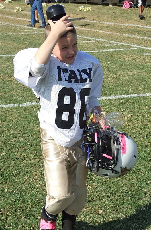Image: IYAA C-Team hard-hitter Kevin “Bubba” McGinnis(88) tries on his gift helmet for size.