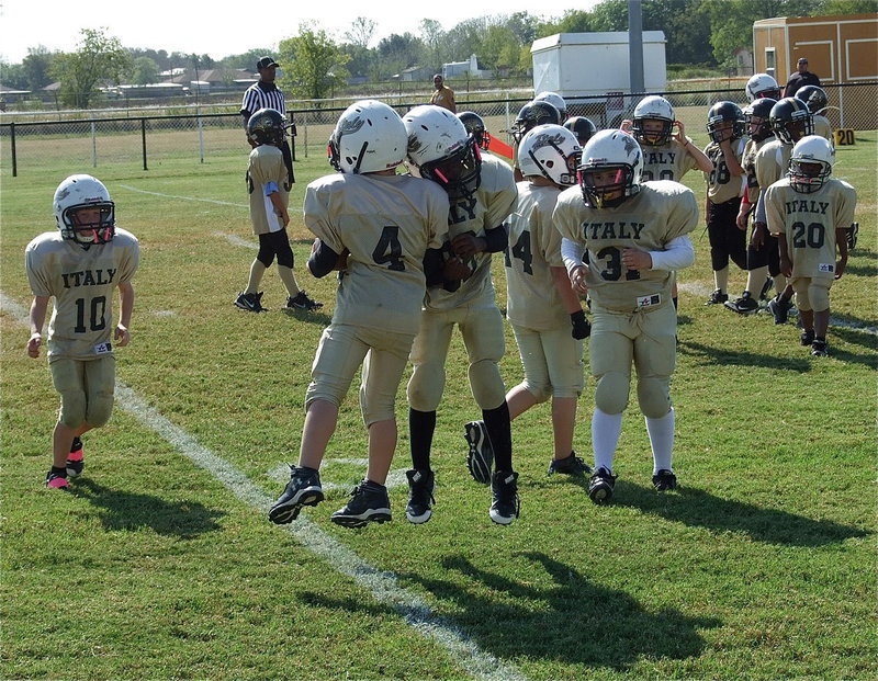 Image: Julius Wilson(33) congratulates Bryce DeBorde(4) above the goal line DeBorde scores a touchdown for the B-Team Gladiators.