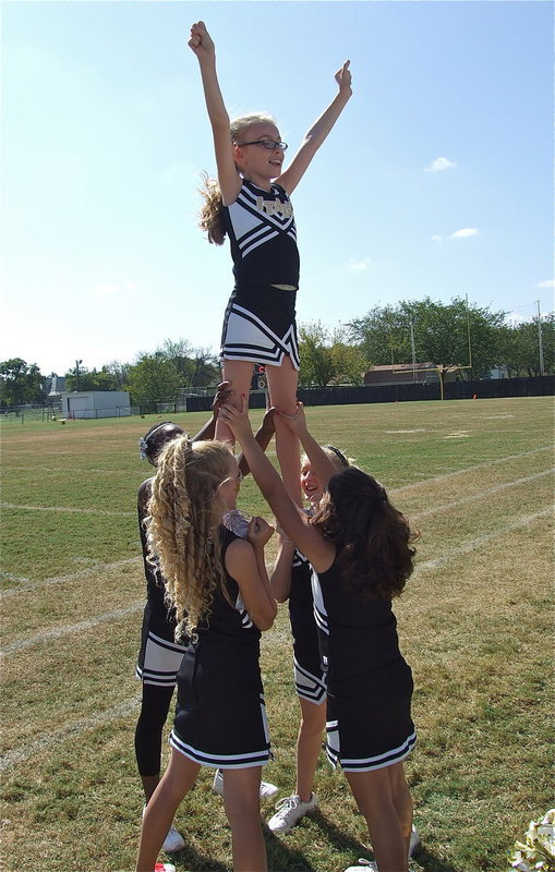 Image: IYAA A-Team cheerleaders Shaniaya Johnson, Taylor Boyd, Courtney Riddle and Hannah Carr hold up Madelyn Chambers to inspire their team!