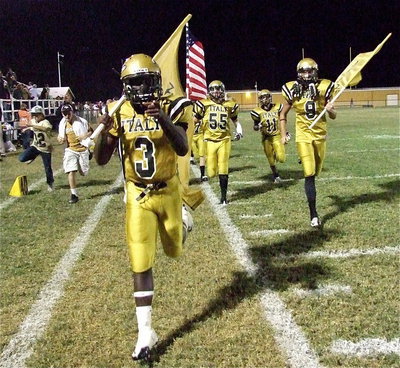 Image: Marvin Cox(3), Cole Hopkins(9), Zackery Boykin(55) and Reid Jacinto(11) lead their teammates out for the second half with water boys Dylan McCasland and Clay Riddle keeping pace.