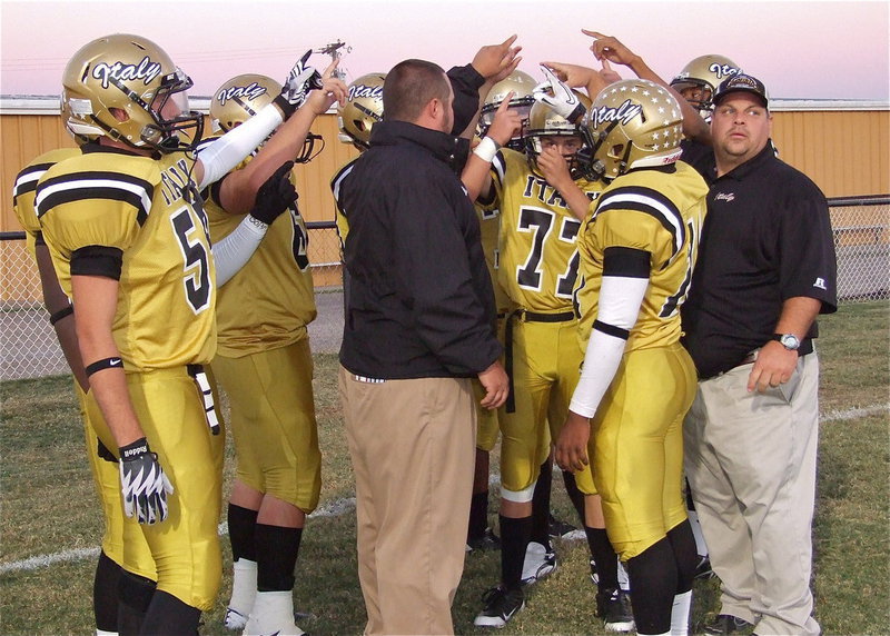 Image: Coaches Brandon Duncan and Brian Coffman get the Gladiator lineman ready for their homecoming battle against the Cross Roads Bobcats