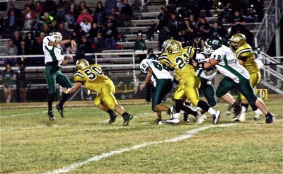 Image: Zain Byers(50) applies pressure forcing an incomplete pass attempt by the Bobcats during the first-quarter.