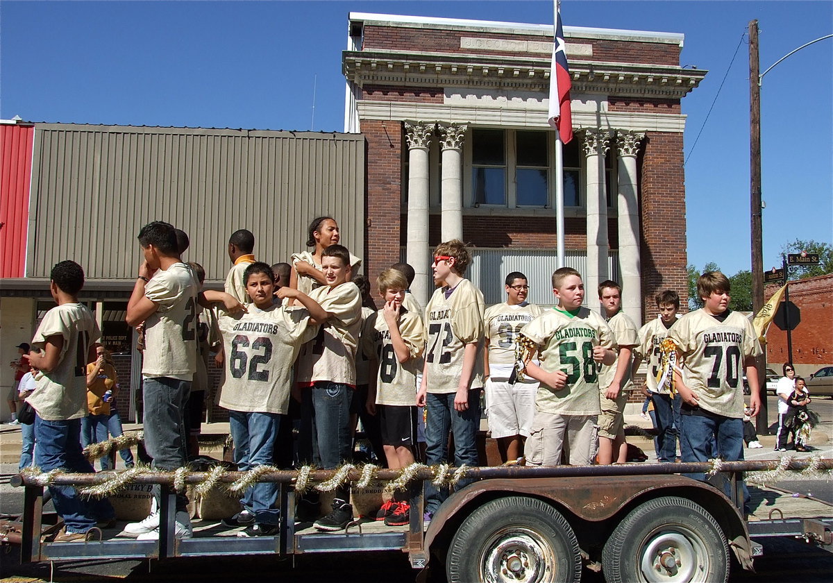 Image: The Italy Junior High Football teams makes their way down main street.