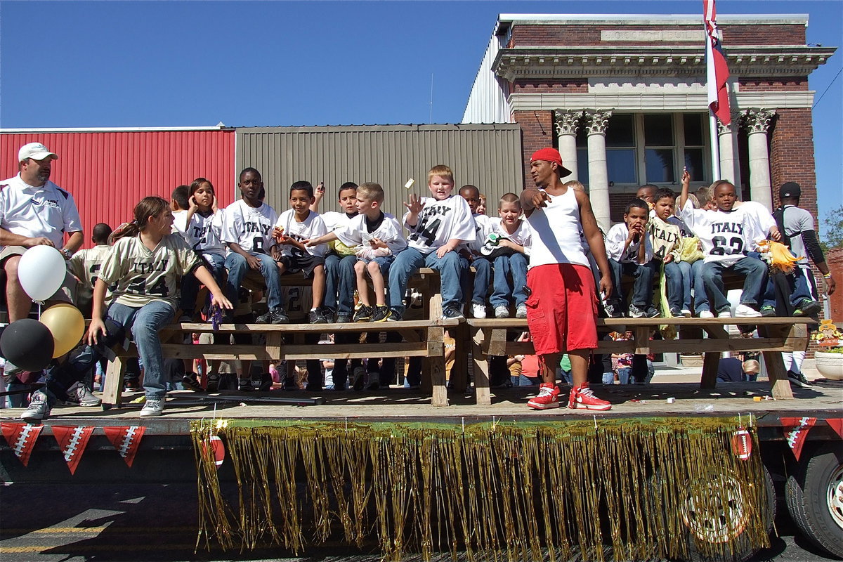 Image: The IYAA football teams toss candy to the crowd on Friday during the parade and then win all three of their homecoming games on Saturday against Hubbard.