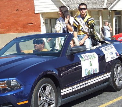 Image: 2012 Homecoming Queen nominee Alyssa Richards and Homecoming King nominee Caden Jacinto(6) are escorted down the parade path by Tina Richards (mom) and Larry Mayberry, Sr.
