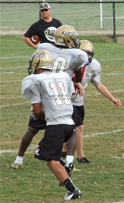 Image: Reid Jacinto(11) catches a pass and then follows his blocking.