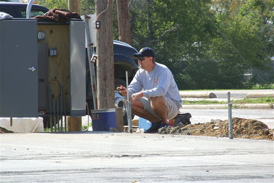 Image: Charles Hyles, of Italy’s EDC board, scans the progress of the foundation. Hyles explained how the bricks from the previous center will be used to construct the pavilion in an effort to retain some of the history associated with the location. Also, cast iron columns from the previous structure will be used for support and a metal step with the original construction company’s identity stamped on it will be embedded in the concrete.