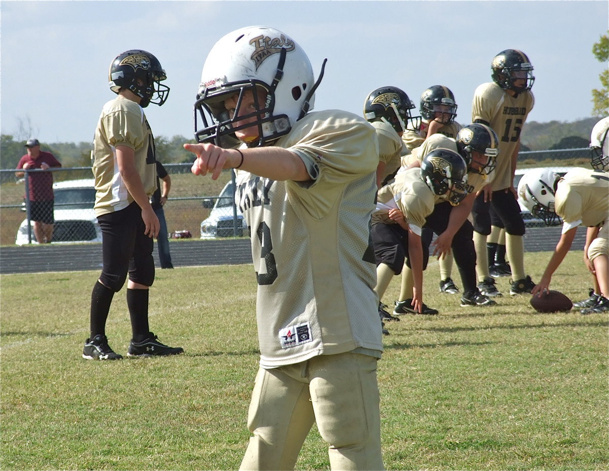 Image: A-team Gladiator, Garrett Cash(28) checks with the sideline official for proper alignment before the snap.