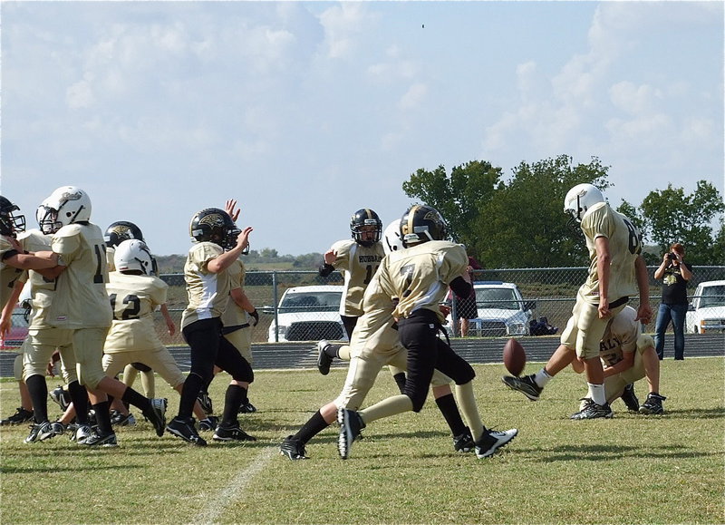 Image: Michael Gonzalez(12) snaps to holder Ryder Itson(2) as Jonathan Salas(82) kicks in the extra-point to give the IYAA A-team a 21-0 advantage in their playoff game against Hubbard.