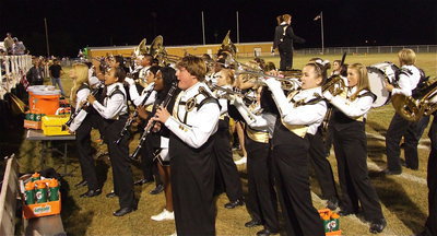 Image: The Gladiator Regiment Marching Band and Color Guard blares loud and proud for their finale in one final salute to their seniors.