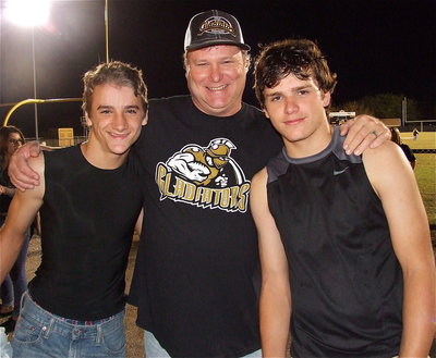 Image: Gladiators Levi McBride(85) and Hunter Merimon(45) receive a proud hug from Mr. Merimon.