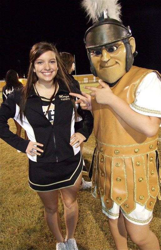 Image: Mascot Reagan Adams points to senior cheerleader Morgan Cockerham, acknowledging it’s Morgan’s time in the spotlight during Senior Night 2012.