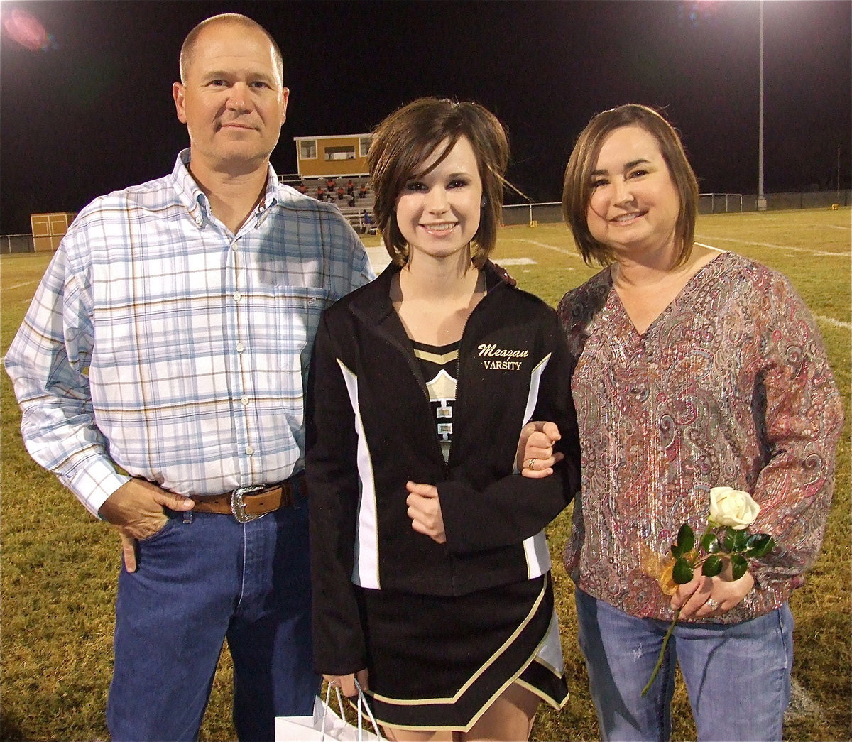 Image: Senior cheerleader Meagan Hooker is escorted by her parents Jerry and Andrea Hooker. Meagan goal’s after graduation are to attend Texas A&amp;M University and become an Environmental Lawyer. Meagan’s hobbies and interests include hunting, spending time with her family and going to church. Her most memorable moment in athletics was cheering at the American Airlines Center her freshman year.