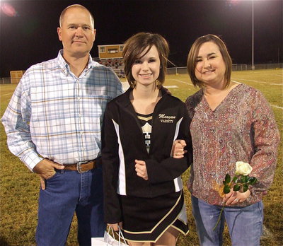 Image: Senior cheerleader Meagan Hooker is escorted by her parents Jerry and Andrea Hooker. Meagan goal’s after graduation are to attend Texas A&amp;M University and become an Environmental Lawyer. Meagan’s hobbies and interests include hunting, spending time with her family and going to church. Her most memorable moment in athletics was cheering at the American Airlines Center her freshman year.