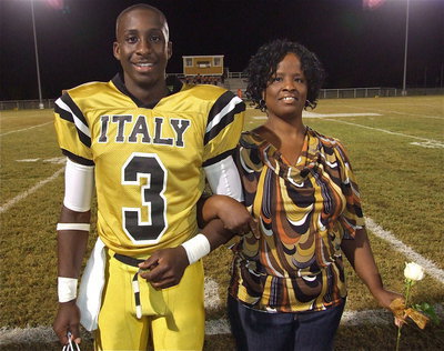 Image: Senior Gladiator Marvin Cox, Jr.(3) is escorted by his mother Sharon Blackshire. Marvin plans to attend Texas State University in San Marcos and become a football coach. His most memorable moment in athletics is when he jumped over a Blooming Grove player and kept running.