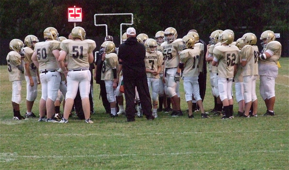 Image: Coach Hank Hollywood talks with his junior high squad.