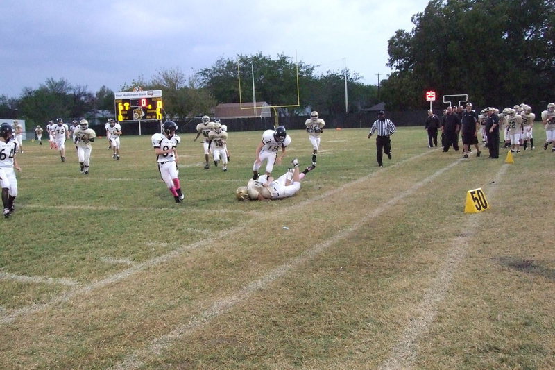 Image: IJH Gladiator Joe Celis(24) runs over a Cayuga tackler to end the first half with Italy leading 6-0.