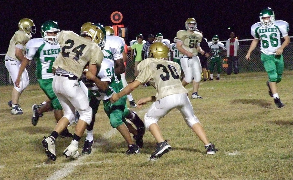 Image: Italy’s Blake Brewer(30) tries to free Joe Celis(24) who has a Bobcat tackler latched on.