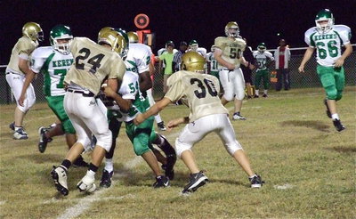Image: Italy’s Blake Brewer(30) tries to free Joe Celis(24) who has a Bobcat tackler latched on.