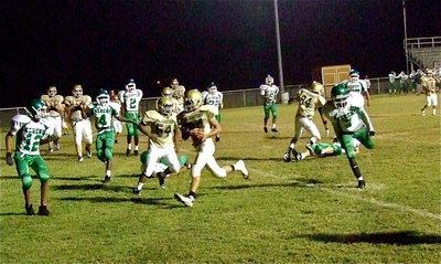 Image: Joe Celis(24) scores a 2-point conversion behind the blocking of Fabian Cortez(84) and Kenneth Norwood(54).