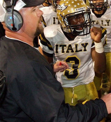 Image: Head coach Hank Hollywood and Marvin Cox(3) inspire team Italy during a timeout.