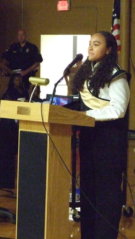 Image: “The National Anthem” was sung by Vanessa Cantu.