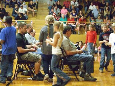 Image: The students gave poppies to the Veterans in the crowd.