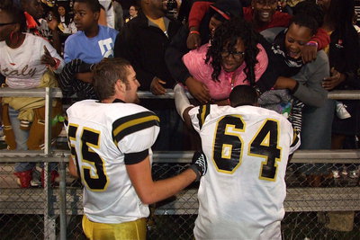 Image: Gladiator seniors Zackery Boykin(55) and Adrian Reed(64) celebrate with their enthusiastic fans after becoming the champs!