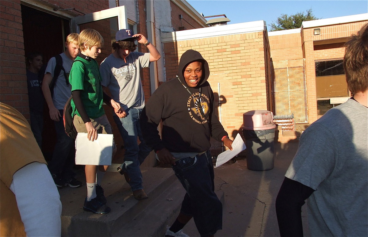 Image: Here come some hungry Gladiators: Darol Mayberry and his teammates Kyle Fortenberry, Clayton Miller and Cody Boyd are ready to enjoy their congratulation cookout after a team practice.