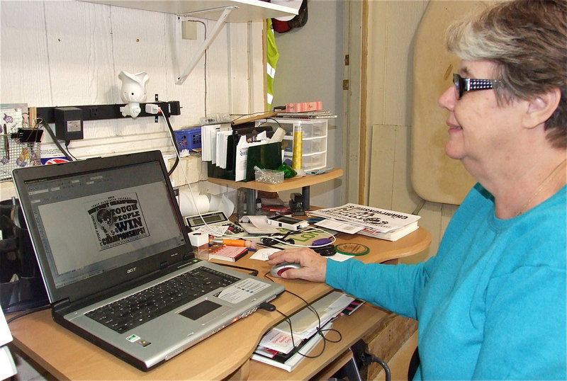 Image: Sandy Dabney with Lil’ Dab Embroidery of Italy, while doing the preliminary work before printing Italy Gladiator Football’s district champion/playoff bound shirts which are now ready for fans to wear to Friday’s game! Italy will challenge Valley View for the area championship being played at Pennington Field, in Bedford.