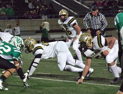 Image: Jalarnce Lewis(21), Kyle Fortenberry (66) and Zain Byers(50) dig in on defense.