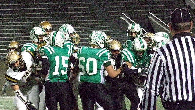 Image: Jalarnce Lewis(21) and Shad Newman(25) latch on to an Eagle runner, Cole Seese(7).