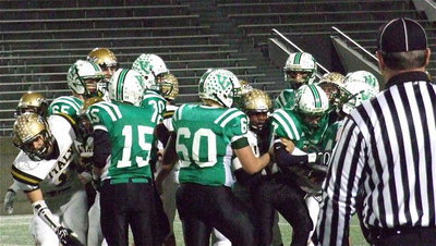 Image: Jalarnce Lewis(21) and Shad Newman(25) latch on to an Eagle runner, Cole Seese(7).